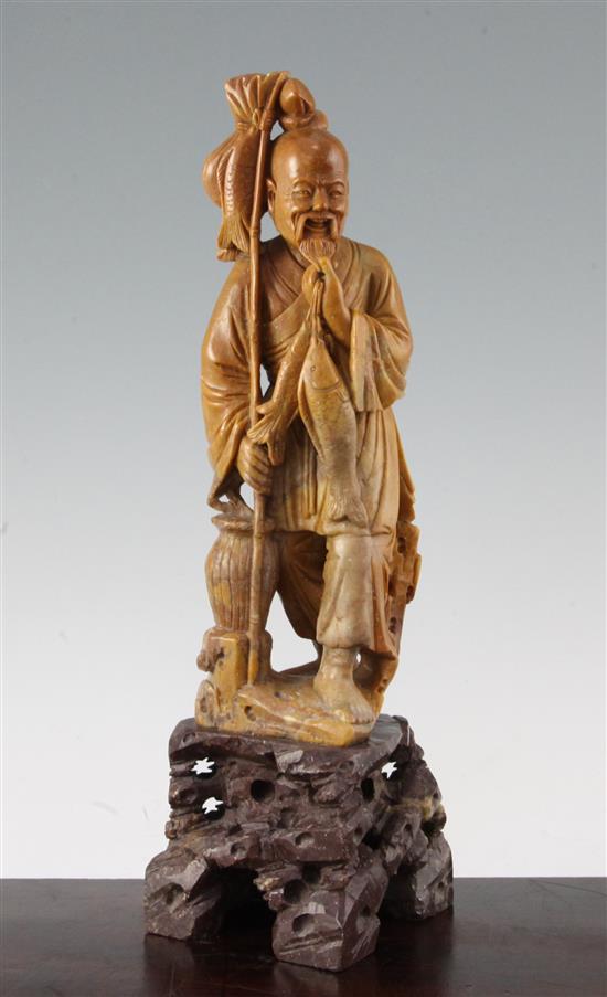 A Chinese soapstone figure of a fisherman, early 20th century, 36cm.